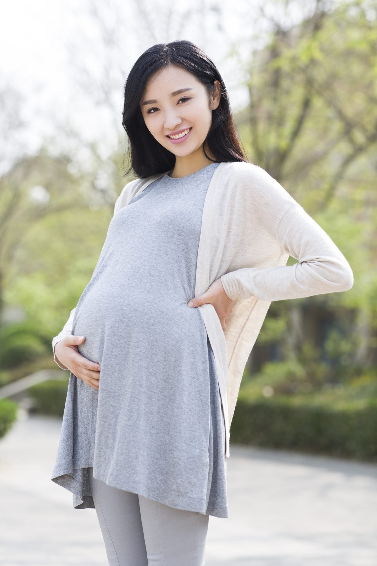 Smiling pregnant woman outdoors